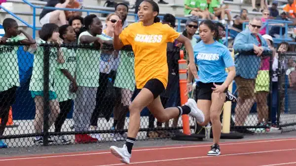 Young women running in a school track race.