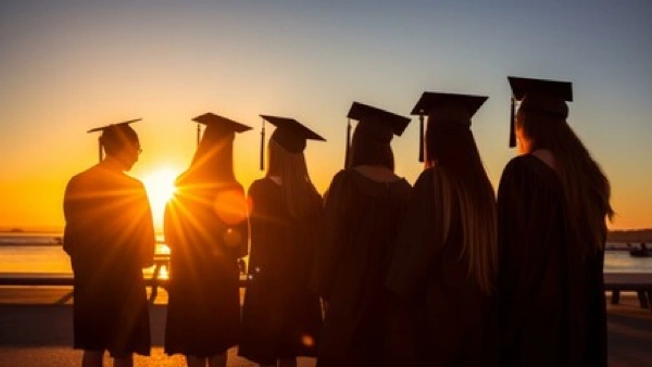 College graduates' silloute at sunset.